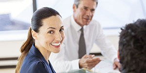 hospital administrator smiling during conference table meeting