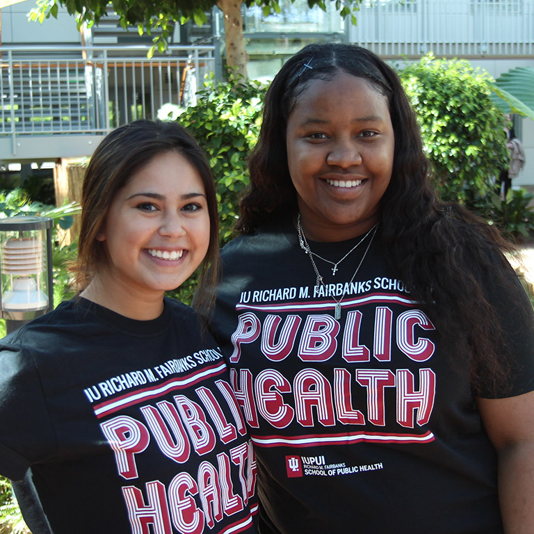 two public health students in fsph shirts