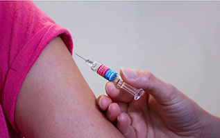person preparing to receive a shot in the arm
