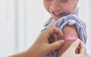 child receives vaccine band-aid on arm