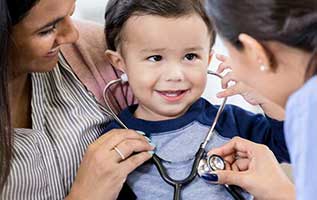 mother and doctor holding stethoscope up to child